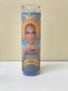 a glass jar with an image of a woman's face on the front and bottom