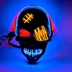 a neon skull mask is shown in blue and red light with the word hell written on it