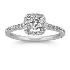 a cushion cut diamond engagement ring with pave set shoulders