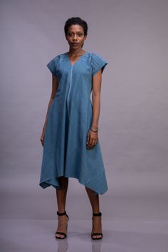 Naturally dyed organic Indigo Cotton women's bias dress with Magyar sleeve, V neck, hand embroidery on shoulders and sleeves.  There are two variations in the shoulder yoke embroidery - 1) Zig-zag pattern 2) Geometric pattern Indigo is among the oldest dyes to be used for textile dyeing and printing. In this collection and organic cotton dyed in the indigo dye. The skilled treatments of the fabrics can be characterized by their absolute lightness and natural fibers that are hand woven, hand dyed V-neck Dresses With Natural Dye, Bohemian Cotton Handloom Dress, Spring Cotton Kurta With Short Sleeves, Spring V-neck Dress With Natural Dye, Spring Cotton Handloom Dresses, Traditional Embroidered Linen Dress For Summer, Traditional Linen Embroidered Dress For Summer, Summer Indigo Cotton Maxi Dress, Spring Cotton Maxi Dress With Natural Dye