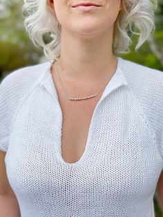 a woman with short white hair and glasses on her head is looking at the camera