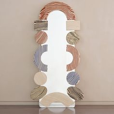 a mirror that is sitting on the floor in front of a wall with circles around it