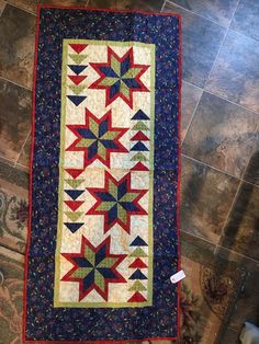 a quilted wall hanging on the floor