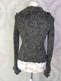 "Vtg black and white colors knitwear handmade women jacket/cardigan with pink textile lining. The sleeves ends, collar and bottom with ruffles. Summer retro large collar granny romantic elegant clothes. Small size S. European 80s fashion. No labeled size, approx.size S or M. US size 6. condition: great vintage. No spots or damages. measurements in lying flat: length 55 cm / 21.5\" in armpit to armpit 44 cm / 17.2\" in shoulders: 41 cm / 16'' in sleeves length from shoulder line: 67 cm / 26.1\" i Black Long Sleeve Sweater With Ruffles, Black Ruffled Sweater For Spring, Black Ruffled Sweater For Winter, Fitted Long Sleeve Ruffle Cardigan, Chic Fitted Sweater With Ruffles, Elegant Long Sleeve Sweater With Ruffles, Vintage Black Fitted Sweater, Elegant Ruffled Sweater For Fall, Elegant Long Sleeve Ruffled Cardigan