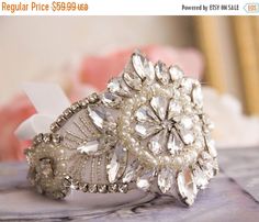 a close up of a ring on a table with flowers in the background and text that reads regular price $ 599 99