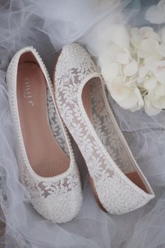 wedding shoes with lace on them and flowers