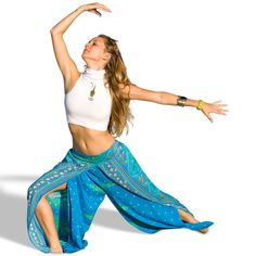 a woman in a white tank top and blue skirt is dancing with her arms outstretched