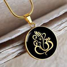 "This Ganesha Necklace Is the Perfect Gift, Whether for Yourself or a Loved One.  Explore all our Witchcraft jewelry here: https://www.etsy.com/in-en/shop/SymbolicPresent?ref=seller-platform-mcnav&section_id=22613465 ➜ Our jewelry is made of high-quality surgical steel with a shatterproof liquid glass coating and an 18k gold finish option. ➜ Engrave onto the back of the Ganesha pendant your loved one's name, your wedding date, an anniversary, or anything else you want to remember and keep you cl Spiritual Round Necklaces For Festive Occasions, Festive Spiritual Round Necklace, Spiritual Round Pendant Necklace For Diwali, Spiritual Round Pendant Necklace For Celebration, Gift Temple Jewelry Necklace, Gift Round Temple Jewelry Necklace, Spiritual Round Necklaces For Festivals, Yellow Gold Necklaces For Festivals, Temple Jewelry Round Pendant Gift