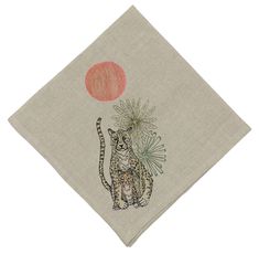 a napkin with an image of a cat holding a red balloon on it's back