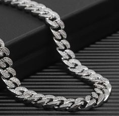 This Cuban link necklace is dripping in high sparkle and high shine. Featuring tons of zircon stones and plated in 18K white and yellow gold, this piece can be worn alone or layered with other necklaces. (Suitable for men & women) Luxury Cuban Link Necklace With Box Chain, Elegant Cuban Link Bling Necklace, Elegant Cuban Link Necklace With Bling, Iced Out Diamond White Chain Link Necklace, Iced-out Chain Link Necklace In Diamond White, Elegant Iced Out Cuban Link Necklace, Elegant Iced Out Link Chain Necklace, White Gold Iced Out Crystal Necklaces, Iced Out Link Chain Necklace With Cubic Zirconia