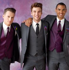 three men in suits and ties posing for a photo with their arms around each other