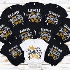 a bunch of black and white shirts with gold lettering on them that says, uncle birthday