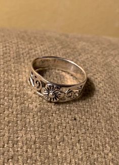 Great little floral motif ring/band . Top has a pretty little flower with a tiny gold center. Flower is surrounded by  filagree work. Solid band back. Size 8. Vintage Filigree Ring With Decorative Band, Vintage Silver Toe Ring With Flower Design, Dainty Adjustable Stackable Rings, Hallmarked, Ornate Silver Engraved Ring For Promise, Vintage Sterling Silver Rings With Round Band, Vintage Sterling Silver Engraved Toe Ring, Dainty Adjustable Hallmarked Stackable Rings, Vintage Sterling Silver Ring With Round Band, Ornate Silver Engraved Promise Ring