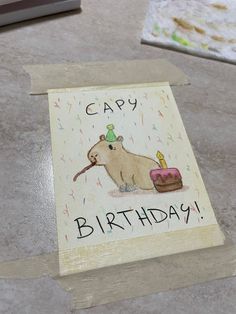 a birthday card with a beaver holding a piece of cake on it's side