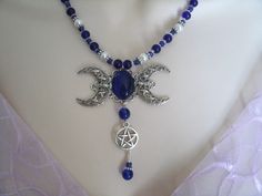 "This beautiful necklace has a cobalt blue catseye set on a sterling silver plated triple moon pendant, a pewter silver pentacle, cobalt blue czech glass beads, pearl beads and pewter silver accent beads. 18\" long. Toggle clasp." Pentacle Necklace, Wicca Jewelry, Triple Moon Goddess, Goddess Jewelry, Wiccan Jewelry, Pagan Jewelry, Triple Moon, Moon Goddess, Moon Pendant