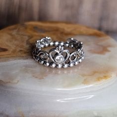 a silver ring sitting on top of a rock