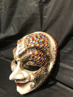 Masquerade Mask,paper mache Joker mask. Traditional and original papier-mache Venetian mask, handmade and decorated with acrylics colors, oil colors and stuggles All our masks are handmade papier-machè masks made in Venice. Our decorators use techniques typical of the Venetian tradition such as stucco, acrylics, gold and silver-leaf, macramè, passementerie, pearls and crequelè to give you a wide range of masks. This shape is available in different colors and it's considered as a very original on Artistic Red Masks And Prosthetics For Mardi Gras, Artistic Masks And Prosthetics For Mardi Gras Carnival, Artistic Masks And Prosthetics For Mardi Gras Costume, Artistic Mardi Gras Costume Masks And Prosthetics, Artistic White Masks For Festivals, Artistic Masquerade Mask For Mardi Gras, Artistic Masks And Prosthetics For Masquerade Carnival, Artistic Masks And Prosthetics For Carnival Masquerade, Artistic Masks And Prosthetics For Mardi Gras Costume Party