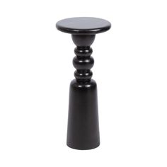 a small black table sitting on top of a white floor