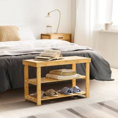 a bedroom with a bed, nightstands and shoes on the floor in front of it