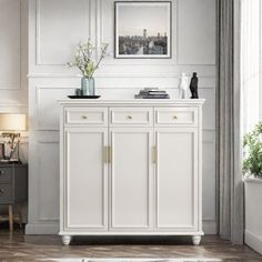 a living room with white furniture and a rug on the floor in front of it