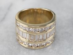 "This bold diamond cocktail band is bright and substantial enough to wear alone, as a right-hand band or cocktail ring. Paired up with the right engagement ring, this would make an interesting and unique wedding piece as well! Metal: 14K Yellow Gold Gem: 34 Diamonds totaling 3.40 Carats, SI1 in Clarity, I in Color Width of Band: 14.0 mm Height off Finger: 3.0 mm Ring Size: 7 Marks: \"14K CG\" Stamped on the inside band SKU #: FXPMWJ8R Each piece has been identified and graded by a Graduate Gemol Yellow Gold Diamond Band, Wide Band Diamond Rings, Diamond Stacking Band, Cocktail Ring Designs, Amethyst Wedding Band, Round Diamond Band, Hand Band, European Cut Diamond Ring, Champagne Diamond Rings