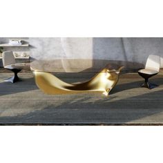 a modern coffee table with gold leaf design