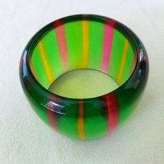 "Fabulous wide Lucite bracelet from the late 1960's early 1970's . Green in color with pink and yellow stripes. Dimensions: 2.5\" interior and 2.5\" wide. In excellent condition. Feel free to convo me with any further questions. Thank you for your interest." Vintage Green Bracelets For Party, Handmade Retro Bangle Bracelet, Green Vintage Cuff Bracelet, Vintage Multicolor Bracelets, Retro Multicolor Bracelets For Gift, Retro Multicolor Bracelets As Gift, Multicolor Retro Bracelets For Gift, Multicolor Retro Bracelet For Gift, Multicolor Retro Bracelet As Gift