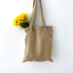 The perfect everyday tote! Great for use as a purse, produce bag, beach bag, and much more! Handmade out of recycled fabric in small batches. Shipped in a biodegradable envelope  - handmade! - dimensions: 16inx14in - handle length: 17in - Machine wash cold, hang dry - NOTE: may not appear exactly as pictured due to different cuts of fabric  - NOTE: once a pattern is sold out it is gone for good! Eco-friendly Brown Canvas Bag, Eco-friendly Recyclable Canvas Bag For Daily Use, Beige Recyclable Tote Shoulder Bag, Recyclable Canvas Tote Bag For Everyday Use, Eco-friendly Brown Shoulder Bag, Eco-friendly Everyday Canvas Gift Bag, Eco-friendly Everyday Reusable Shoulder Bag, Eco-friendly Beige Beach Bag For Daily Use, Everyday Brown Recyclable Bag