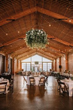 the inside of a large room with tables and chairs set up for an elegant dinner