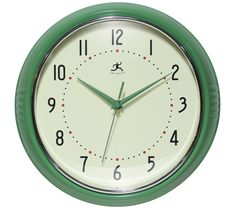 a green and white wall clock with numbers on the face, against a white background