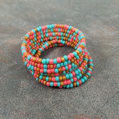 multicolored beaded bracelets sitting on the ground