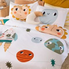 a bed with an animal themed comforter and pillowcases on top of it