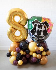 Lasts 3 to 5 days. See Longevity Notes. Inflated with air - this item will not float. This item is Ready-To-Party™ Handcrafted piece. May vary from picture. Features Make a bold birthday statement for a fun Harry Potter themed kids birthday! Use this giant balloon with tassel garland and number pedestal to dress up any space! This design includes a gold mylar number and Hogwarts Shield mylar balloon for extra fun. This set is Ready-To-Party™. Comes inflated and assembled. Simply unbag and enjoy. Details NUMBER PEDESTAL Color Palette:Balloon - Mahogany, Brass Gold, Lemon Spritz, BlackFoil - Gold number, Hogwarts Shield Dimensions:H (per foil) - approx. 3ftW (per foil) - approx. 1.5ftW (total) - approx. 3ft Material:Balloon - biodegradable latex and foil GIANT BALLOONColor Palette:Balloon - Lemon Spritz, Harry Potter Themed Party, Giant Balloon, Balloon Tassel, Harry Potter Theme Party, Sweets Table, Giant Balloons, Tassel Garland, Gold Number