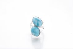 Enjoy the new collection of double stone rings is now out and about! Check these state of the art creations from one of our greatest artisans. Two stones Larimar rings so creatively made and with so much love for you to enjoy and maybe, just maybe show off a little :)  The marvelous blue Avaya Larimar ring reminds us of the beautiful and calm waters of our South beaches. Wear it and your hands will transport you to seas of tranquility. Make it yours!– Material: Larimar gemstone and 925 silver– W Elegant Blue Larimar Rings, Adjustable Blue Larimar Ring, Oval Blue Larimar Jewelry, Hallmarked Larimar Jewelry, Blue Wedding Rings With Natural Stones, Wedding Blue Rings With Natural Stones, Blue Larimar Round Rings, Blue Larimar Jewelry For Anniversary, Elegant Round Larimar Jewelry