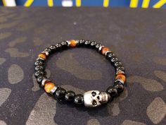 Black beaded bracelet accent by brown beads, featuring a metal skull. Black Beaded Bracelet, Metal Skull, Black Beaded Bracelets, Skull Bracelet, Black Beads, Beaded Bracelet, Black And Brown, Jewelry Bracelets, Beaded Bracelets