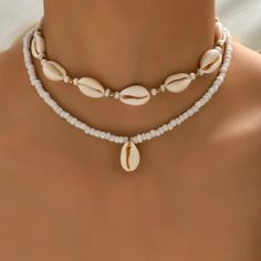 Elevate your style with our Trendy Geometric Shell Necklace, a perfect blend of modern design and natural elements. At 43cm in length, this necklace features bold geometric shapes paired with delicate shells, creating a unique and eye-catching piece. Its combination of sleek lines and organic textures makes it versatile for both casual and formal looks. Whether layered or worn alone, this trendy necklace adds a chic, beach-inspired touch to any outfit. Ideal for those who love modern elegance wi Summer Beach Jewelry, Beads Choker, Choker Pendant, Rice Bead, Neck Choker, Beaded Pendant Necklace, Beaded Choker Necklace, Themed Jewelry, Shell Pendant