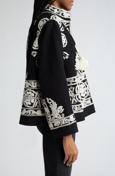 This runway-featured wool jacket was inspired by a vintage Kashmiri jacket and reproduces its white silk-stitched embroidery and long tassels. 23" length (size Small) Front hook-and-eye closure Band collar Lined 100% wool Dry clean Imported Designer Clothing Victorian Jacket Woman, Adding Embroidery To Clothes, Haute Couture Menswear, Shirt Collar Embroidery, Blouse With Jacket, Collar Embroidery Design, Runway Embroidery, Embroidery Outfits, All Saints Clothing