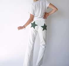 Fabulous 90s white jeans. Low waist w/ slightly bell bottom leg. This fit is perfect for a smaller waist w/ curvy hips. Zipper fly. White denim with contrasted green stars on back. No stretch. In excellent condition.  Measurements are taken flat. Fits actual 28" waist Waist = 14 in / 35.5 cm Hip = 19 in / 48 cm Rise = 11 in / 27 cm Inseam = 30 in / 76 cm Total length = 40 in / 102 cm  Model is 5'6", 26" waist, 36" hip and here wears the size 26" W. Fit guide: It's always a good idea to measure s White Y2k Jeans For Summer, Off White Jeans With Stars, White High Waist Y2k Pants, Low Rise White Jeans, Pants Low Waist, White Non-stretch Denim Pants, Curvy Hips, White Flares, White Denim Jeans