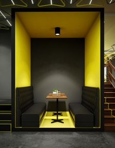 an empty room with two benches and a table in the center, next to some stairs