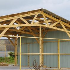 a large wooden structure sitting in the middle of a parking lot