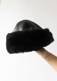 Leather and Shearling Cap in Black from Cawley. Cozy hat in black sheepskin with seaming details. Super warm and perfect for cold days. Need a second opinion? If you have special requests or just need advice, please reach out to hello@shop-vestige.com. 100% Sheepskin. Handcrafted in London Winter Black Sheepskin Hats, Black Hat With Faux Fur Lining, Black Hats With Faux Fur Lining For Cold Weather, Black Hats With Plush Lining For Cold Weather, Black Hat With Faux Fur Lining And Ear Flaps, Black Hats With Plush Lining And Ear Flaps, Shearling Accessories, Hats Short Hair, 90s Style Icons