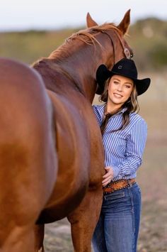 a woman standing next to a brown horse