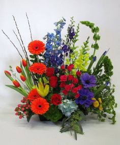 an arrangement of colorful flowers on a white background