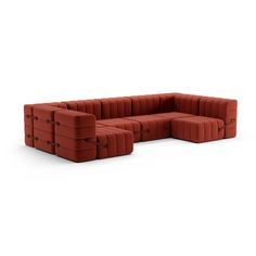 a red sectional couch sitting on top of a white floor