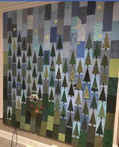 a large quilt hanging on the side of a wall