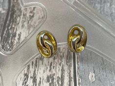 A pair of  gold coloured oval swirl  earrings with  standard clip on backs  Each earring measures 2 cm long and 1.5 cm wide . We have a large selection of vintage jewellery available here https://etsy.me/3jpPZw1 Here at Otherworld Vintage, we offer a curated selection of vintage items that are unique and timeless. All of our items are pre-owned and may have some signs of wear and tear, which we believe add to their charm and character. We do our best to describe any major flaws in our listings, but please note that vintage items may also have some minor imperfections or quirks that are not found in modern production. If you have any questions about an item, need specific measurements, or want more photos of a certain detail, please don't hesitate to contact us. We are happy to assist you a Gold Metal Clip-on Earrings For Formal Occasions, Gold Metal Clip-on Earrings For Anniversary, Retro Gold Oval Earrings, Retro Gold Clip-on Earrings For Anniversary, Retro Gold Round Clip-on Earrings, Retro Round Gold Clip-on Earrings, Vintage Gold Oval Earrings, Retro Oval Earrings For Formal Occasions, Retro Gold Earrings For Anniversary