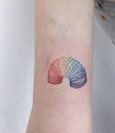 a woman's arm with a colorful tattoo on it