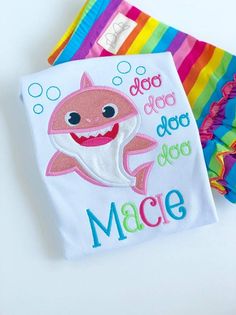 two personalized beach towels one with a shark and the other with a name on it