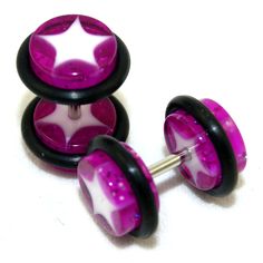 three purple and black glass knobs with stars on them