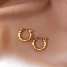 Mini chunky hoops perfect for everyday wear. Smaller than the Puv chunky hoops but bigger than the Infinity Huggies, and just as lightweight! 14k Gold Fill Diameter: 3/4" Sold as a pair Make your jewelry last! Click here for jewelry care. Need a gift box? We got you. Bracelets Dainty, Name Bracelets, Dainty Rings, Layering Necklaces, The Infinity, Name Bracelet, Dainty Ring, Gold Filled Jewelry, Layered Necklaces